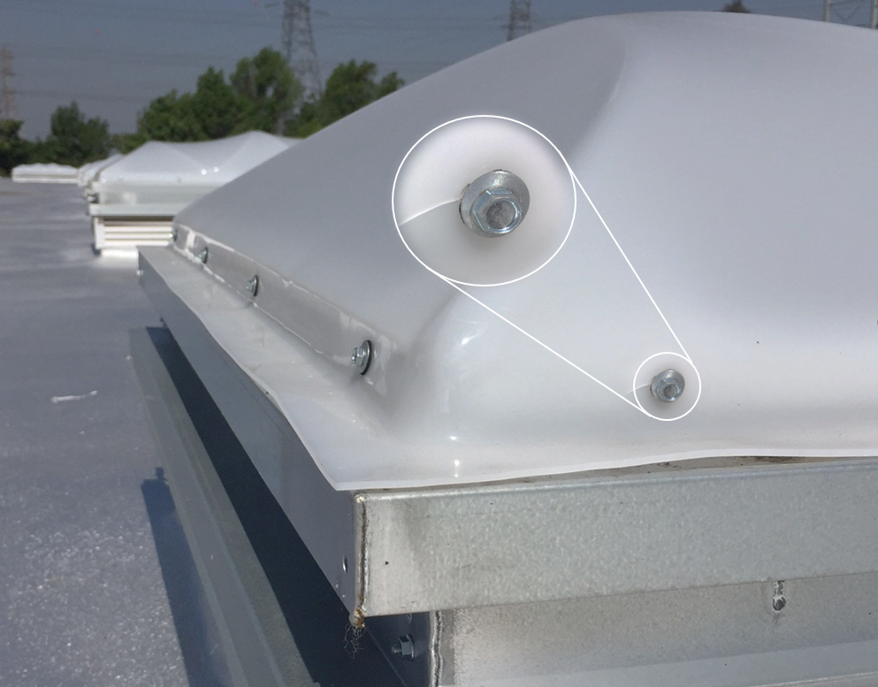 Image 1: Non-Listed Capless unit example. A capless unit is when the screws are fastened through the glazing typically causing cracks and weakening the dome. There are zero code compliant capless units.